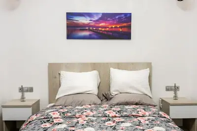 a bedroom with a bed and two night stands at The Golden home 1 in Piraeus