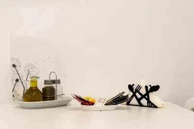 a white table with two dishes of food and scissors at The Golden home 1 in Piraeus