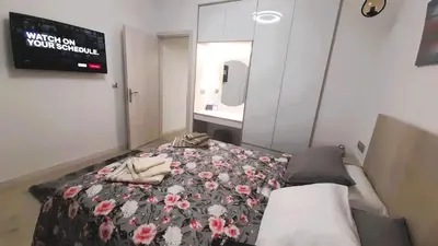 a bedroom with a bed with flowers on it at The Golden home 1 in Piraeus