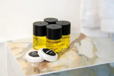 two bottles of yellow paint sitting on a counter at Celia Residence in Athens