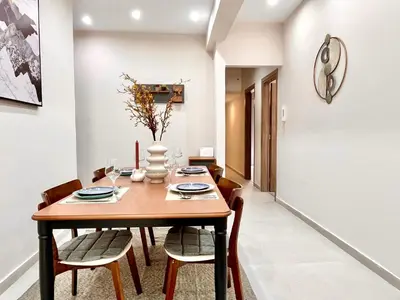 a dining room with a wooden table and chairs at Green House near Athens Center in Athens