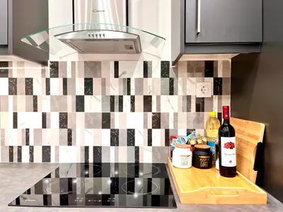 a kitchen counter with two bottles of wine on a cutting board at Green House near Athens Center in Athens