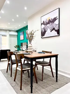 a dining room with a wooden table and chairs at Green House near Athens Center in Athens