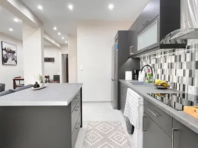 a kitchen with gray cabinets and a counter top at Green House near Athens Center in Athens