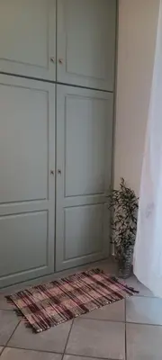 a room with white cabinets and a rug on the floor at Athenian Asty Guesthouse in Athens