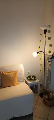 a room with a bed and a lamp and a table at Athenian Asty Guesthouse in Athens