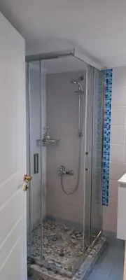 a shower with a glass door in a bathroom at Athenian Asty Guesthouse in Athens