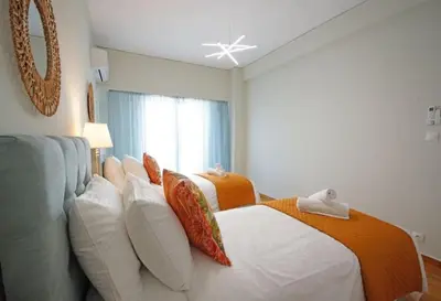 a hotel room with two beds and a window at Alkuoni lux flat at PFaliro in Athens