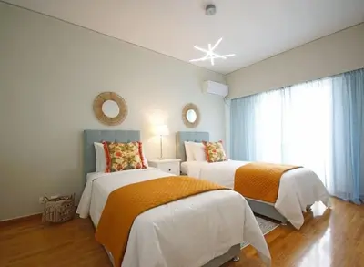 a bedroom with two beds and a window at Alkuoni lux flat at PFaliro in Athens