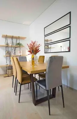 a dining room with a wooden table and chairs at Alkuoni lux flat at PFaliro in Athens