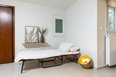 a white room with a bench and a window at Mystique One Bedroom Apartment by BluPine in Athens