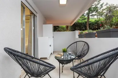 a patio with two chairs and a glass table at Mystique One Bedroom Apartment by BluPine in Athens