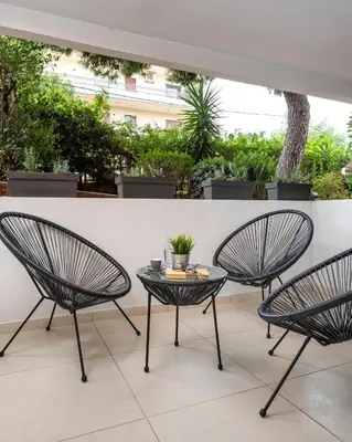 two chairs and a table on a patio at Mystique One Bedroom Apartment by BluPine in Athens