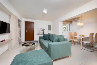 a living room with a couch and a table at Mystique One Bedroom Apartment by BluPine in Athens