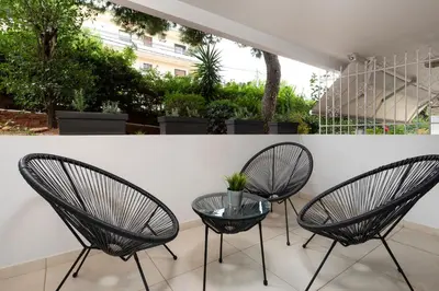 two chairs and a glass table on a patio at Mystique One Bedroom Apartment by BluPine in Athens