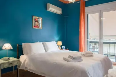a blue bedroom with a bed with towels on it at Casa de Colores, next to the metro in Athens