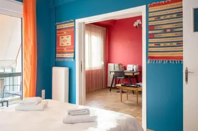 a bedroom with blue and red walls and a bed at Casa de Colores, next to the metro in Athens