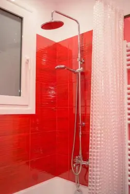 a red bathroom with a shower with a red wall at Casa de Colores, next to the metro in Athens