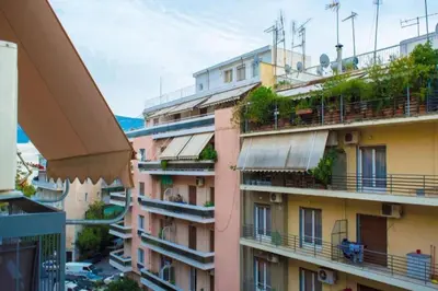 a view of an apartment building with balconies at Casa de Colores, next to the metro in Athens