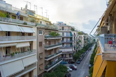a view of a city street with buildings at Casa de Colores, next to the metro in Athens