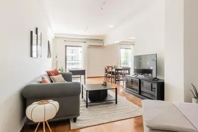 a living room with a couch and a table at Radiant Retreat in Paleo Faliro by UPSTREET in Athens
