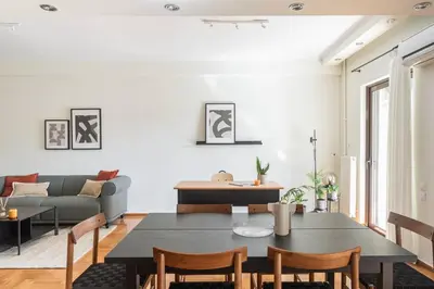 a living room with a table and a couch at Radiant Retreat in Paleo Faliro by UPSTREET in Athens