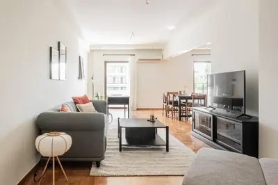 a living room with a couch and a table at Radiant Retreat in Paleo Faliro by UPSTREET in Athens