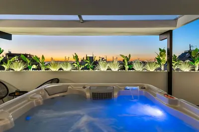 a hot tub in a room with a view at Sunset Escape & Spa in Athens