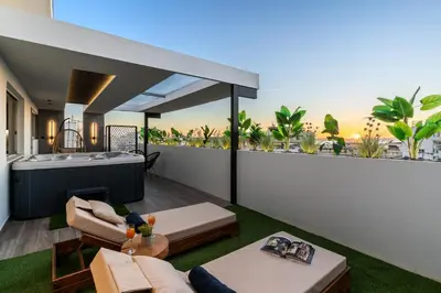 a living room with a bath tub and a balcony at Sunset Escape & Spa in Athens