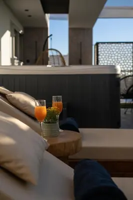 two glasses of orange juice sitting on a table at Sunset Escape & Spa in Athens