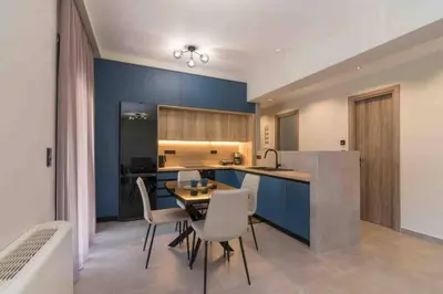a kitchen and dining room with a table and chairs at Blue Pearl at Glufada sea side in Athens