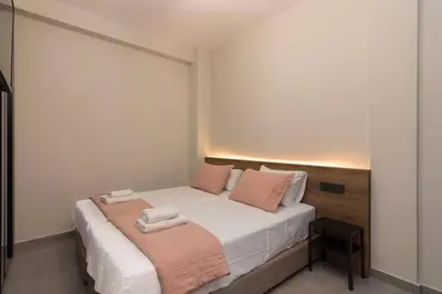 a bedroom with a bed with two towels on it at Blue Pearl at Glufada sea side in Athens