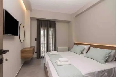 a bedroom with a large bed with towels on it at Blue Pearl at Glufada sea side in Athens