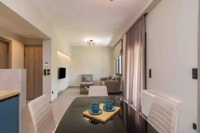 a kitchen and living room with a table and chairs at Blue Pearl at Glufada sea side in Athens