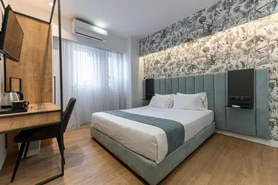 a hotel room with a bed and a desk at Kriel Suites by LIV Homes in Athens