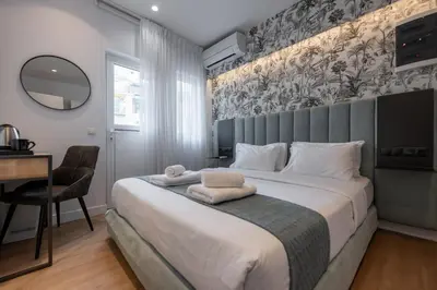 a bedroom with a large bed and a desk at Kriel Suites by LIV Homes in Athens