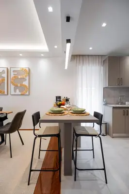 a kitchen and dining room with a table and chairs at Sesilia Luxury Apartments in Athens