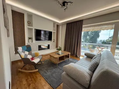 a living room with a couch and a tv at Sesilia Luxury Apartments in Athens
