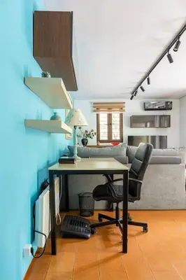 an office with a desk and a chair and a couch at Private Garden Home next to the beach and market in Athens