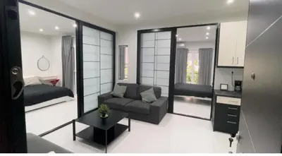 a living room with a couch and a bed in it at George375 flat Park&Nat.Library&Opera/Onasseio/Rea in Athens