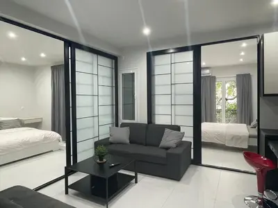 a living room with a couch and a bedroom at George375 flat Park&Nat.Library&Opera/Onasseio/Rea in Athens