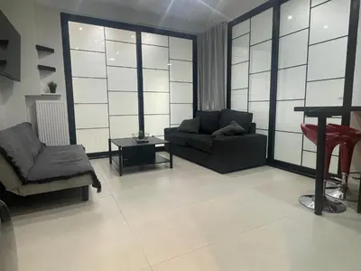 a living room with a couch and a chair at George375 flat Park&Nat.Library&Opera/Onasseio/Rea in Athens