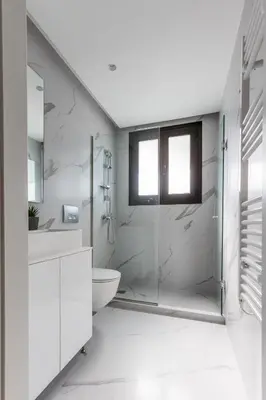 a bathroom with a shower and a toilet and a sink at Varkiza Luxury Suites by Raise in Vari
