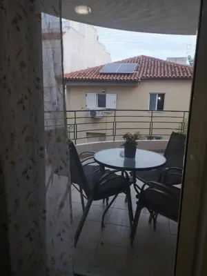 a patio with a table and chairs on a balcony at Athenian Luxury apartment, near metro station Chalandri, Nu 1 in Athens