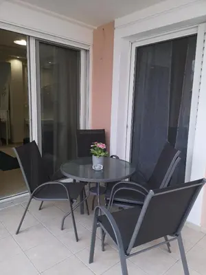 a black table and chairs with a potted plant on it at Athenian Luxury apartment, near metro station Chalandri, Nu 1 in Athens