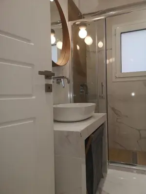 a bathroom with a white sink and a mirror at Athenian Luxury apartment, near metro station Chalandri, Nu 1 in Athens