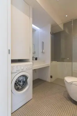 a bathroom with a washing machine and a toilet at Athens Trikoupi Suite E1 in Athens