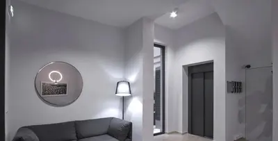 a living room with a couch and a mirror at Athens Trikoupi Suite B3 in Athens