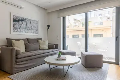 a living room with a couch and a table at Athens Trikoupi Suite B3 in Athens