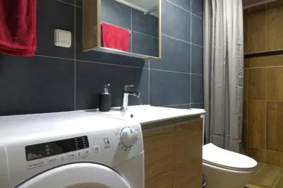 a bathroom with a washing machine and a sink at You & Me Cozy Apartments BY ZAIN in Athens